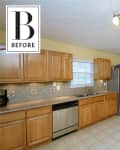 Spacious kitchen with wooden cabinets, stainless steel appliances, tiled backsplash, and track lighting.