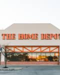 The Home Depot storefront with orange signage and a "Now Hiring" sign in the window.