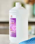 CVS Health isopropyl rubbing alcohol bottle on a kitchen counter with a blue cloth.