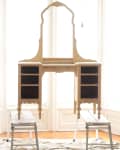 Wooden vanity frame on sawhorses in front of large windows, ready for restoration.