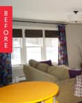 Living room with beige sofa, colorful curtains, wall-mounted TV, and black console with sunflowers and decor.