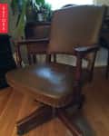 Brown leather office chair with wooden arms and legs on a hardwood floor, labeled "Before."