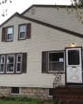 Two-story beige house with brown shutters, front porch, and a "Before" label on the left.