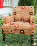 Floral-patterned armchair with dark wooden legs on grass, labeled "Before."