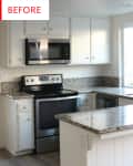 White kitchen with granite countertops, stainless steel appliances, and large window.