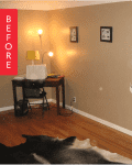 Living room with wooden stairs, desk with lamp, framed art, and cowhide rug.