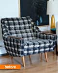 Plaid armchair with wooden legs next to a lamp and abstract artwork.
