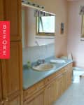 Bathroom with wooden cabinets, light blue countertop, sink, toilet, and floral window valance. "Before" label on the side.