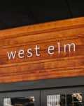 West Elm store entrance with wooden sign and glass doors.