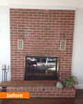 Red brick fireplace with glass doors, flanked by two vents, a plant, and a candle holder on a wooden floor.