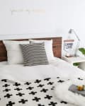 An Ikea malm bed with white and black geometric designs.