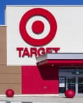 Target store entrance with large red logo, automatic glass doors, and red bollards.