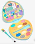 Heart-shaped Polly Pocket makeup palette with colorful eyeshadows and a small brush.