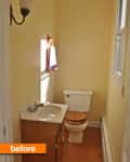 Narrow bathroom with a small sink, wooden cabinet, and toilet.