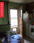Cluttered kitchen with green walls, wooden cabinets, fridge, microwave, and open back door.