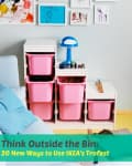 IKEA Trofast storage unit with pink bins, blue cloud lamp, toy cars, and framed children's art on the wall.