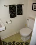 Small bathroom with toilet, sink, patterned towels, and framed art on wall. "Before" text at bottom.