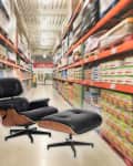 Black leather lounge chair and ottoman in a warehouse aisle with stocked shelves.