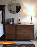 Bedroom with wooden dresser, books, a lamp, and a round mirror above.