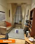 Small living room with beige sofa, orange throw, zigzag rug, desk, and bookshelves. Large calendar on wall, curtains drawn.