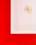 Framed sketch of a smiling woman with yellow highlights on a red wall.
