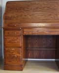 Roll-top wooden desk with multiple drawers and a central open shelf, labeled "Before" on the left side.