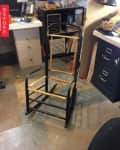 Chair frame in a workshop with a desk, filing cabinet, and tools. "Before" label on the left.