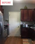 Kitchen with dark wood cabinets, stainless steel appliances, and a colorful rug on wooden floor.