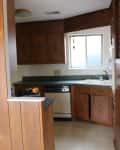 Before: a drab kitchen with wood paneling