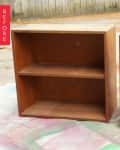 Two wooden bookshelves with two shelves each, labeled "Before," placed outdoors on a concrete surface.