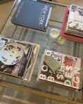 Gold frame glass square coffee table styled with books and candles and trinkets