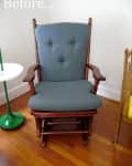 Blue upholstered wooden rocking chair on hardwood floor next to a green side table.