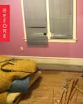 Empty room with pink walls, broken blinds, a small ladder, and scattered wooden planks on the floor.