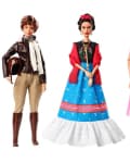 Three dolls in historical outfits: aviator with leather jacket, artist in colorful dress, and scientist in pink dress.