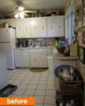 Cluttered kitchen with white cabinets, ceiling fan, tiled floor, and various items on counters and shelves.