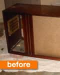 Vintage wooden console with fabric speaker panels, one torn, labeled "before" on an orange tag.