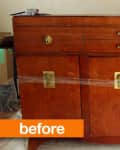 Wooden sideboard with brass handles, two drawers, and three cabinet doors, wrapped in plastic, labeled "before."