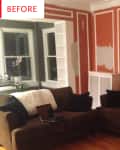 Living room with brown sofas, orange walls with white trim, and a bay window with plants.
