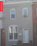 Two-story gray townhouse with white door and windows, labeled "Before."