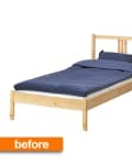 Simple wooden bed frame with blue bedding and pillow.