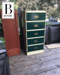 Green and beige five-drawer dresser on a wooden deck, next to a brown cabinet door.