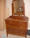 Wooden dresser with three drawers and attached mirror, labeled "before," on tiled floor.