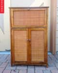 Wooden cabinet with woven rattan doors on a brick patio, labeled "Before" on the left.