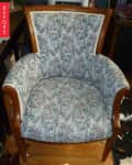 Floral upholstered armchair with wooden frame on a hardwood floor, labeled "Before."