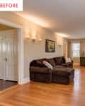 Living room with brown sectional sofa, armchair, brick fireplace, and wall-mounted TV, featuring hardwood floors and soft lighting.