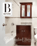 Small bathroom with dark wood vanity, granite countertop, and tiled walls featuring a mosaic border.