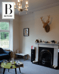 Living room with a chandelier, blue sofa, green coffee table, and decorative deer head above a fireplace.