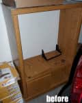 Wooden entertainment center with a shelf, small hardware pieces, and a stack of boxes nearby, labeled "before."