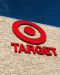 Target store exterior with red logo on a stone wall under a clear blue sky.