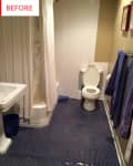 Bathroom with blue penny tile floor, white shower curtain, toilet, and towels on a rack.